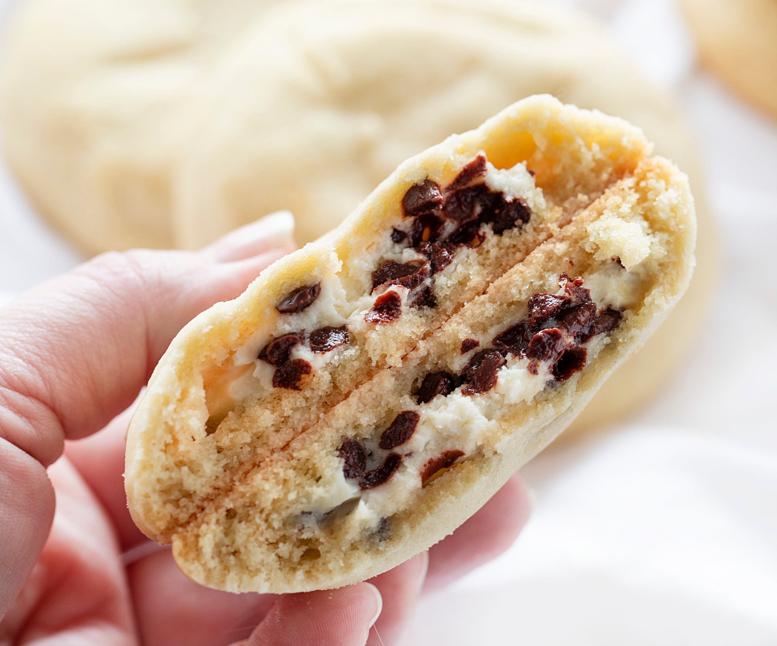 Sugar Cookies with Chocolate Chip Cheesecake Filling Broken in Half