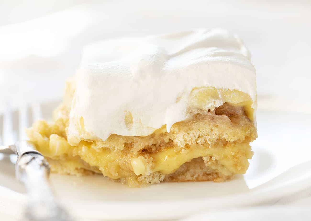 Piece of The Ultimate Banana Pudding on a White Plate with Fork