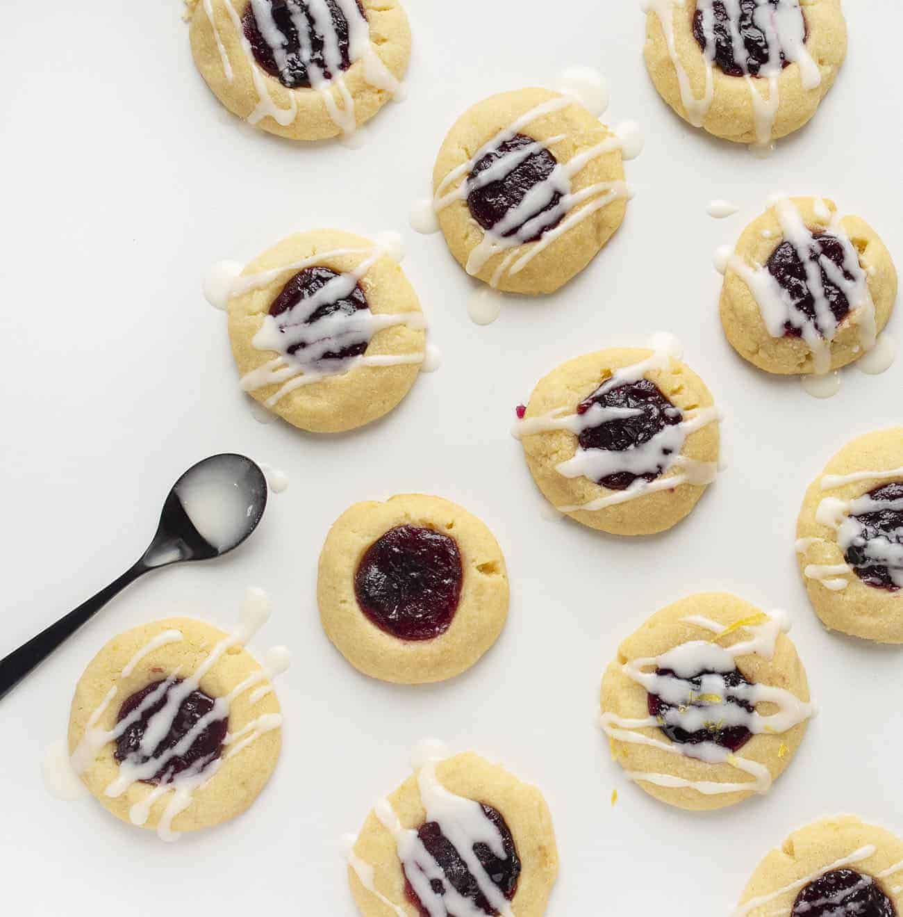 Overhead Image of Lemon Blueberry Thumbprint Cookies with Glazing Spoon
