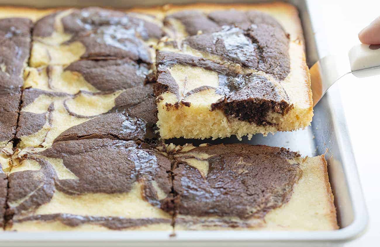 Picking Up a Slice of Marble Cake from Sheet Pan