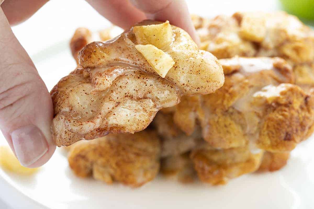 Hand holding Baked Apple Fritter showing the inside