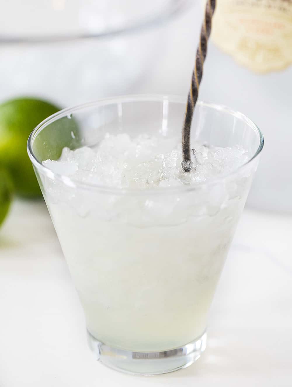 Stirring a Vodka Gimlet in Glass of Crushed Ice