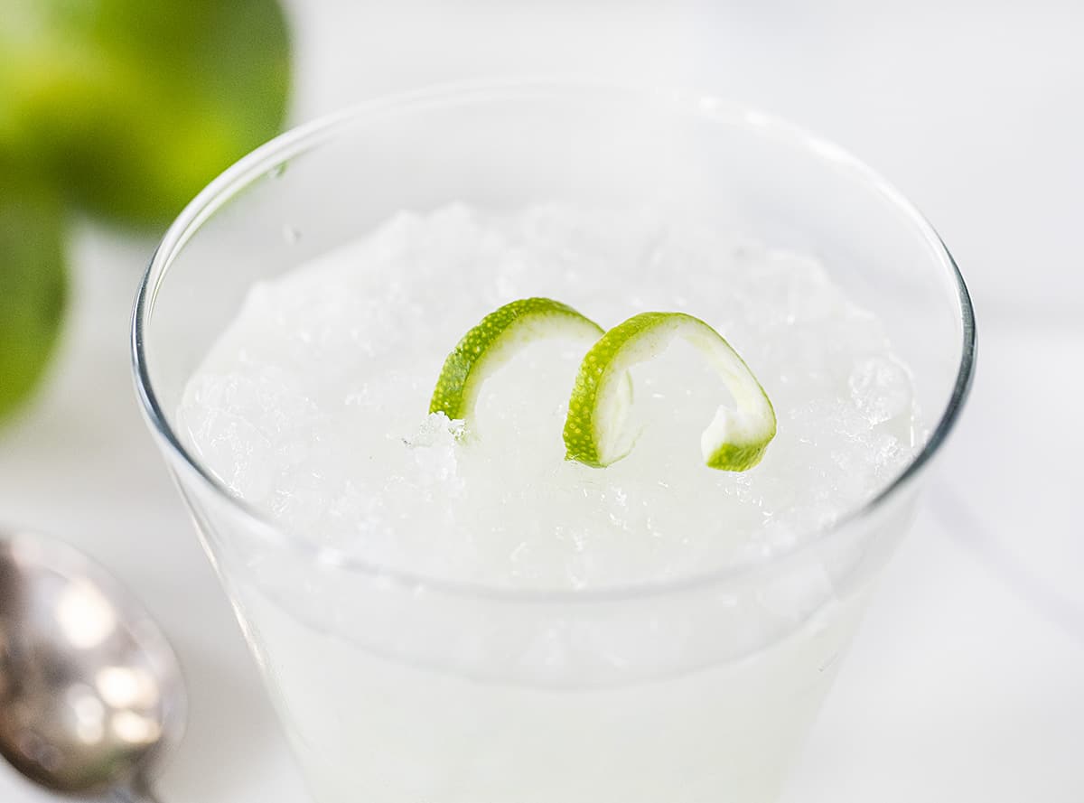 This Vodka Gimlet is made a bit sweeter by adding homemade simple syrup to the recipe. vodka gimlet, homemade simple syrup, simple syrup recipe, cocktail recipes, vodka drinks, i am baker, iambaker A Prepared Vodka Gimlet with Lime Garnish in Glass of Ice