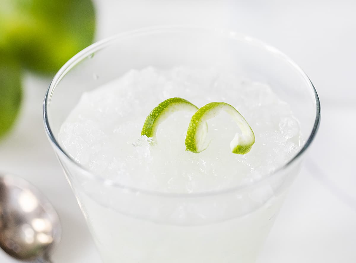 A Prepared Vodka Gimlet with Lime Garnish in Glass of Ice