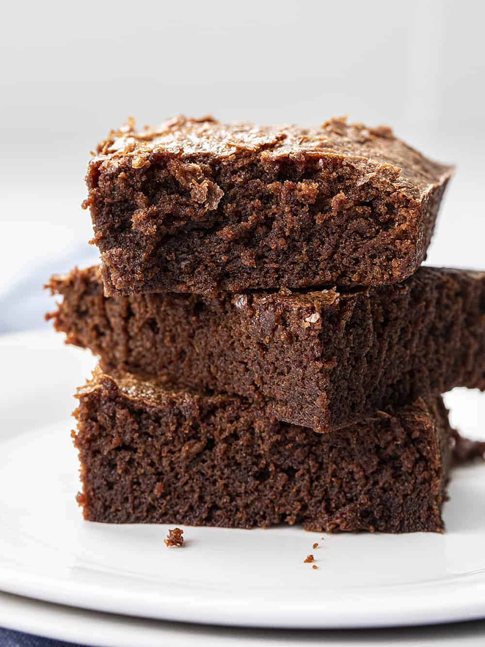 Three Sourdough Brownies Stacked on White Plates