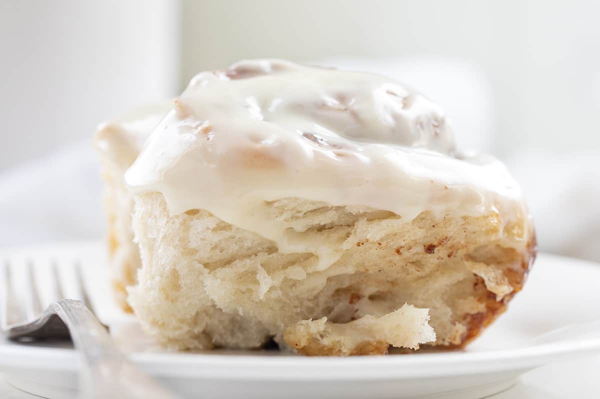 One Sourdough Cinnamon Roll on White Plate with Fork