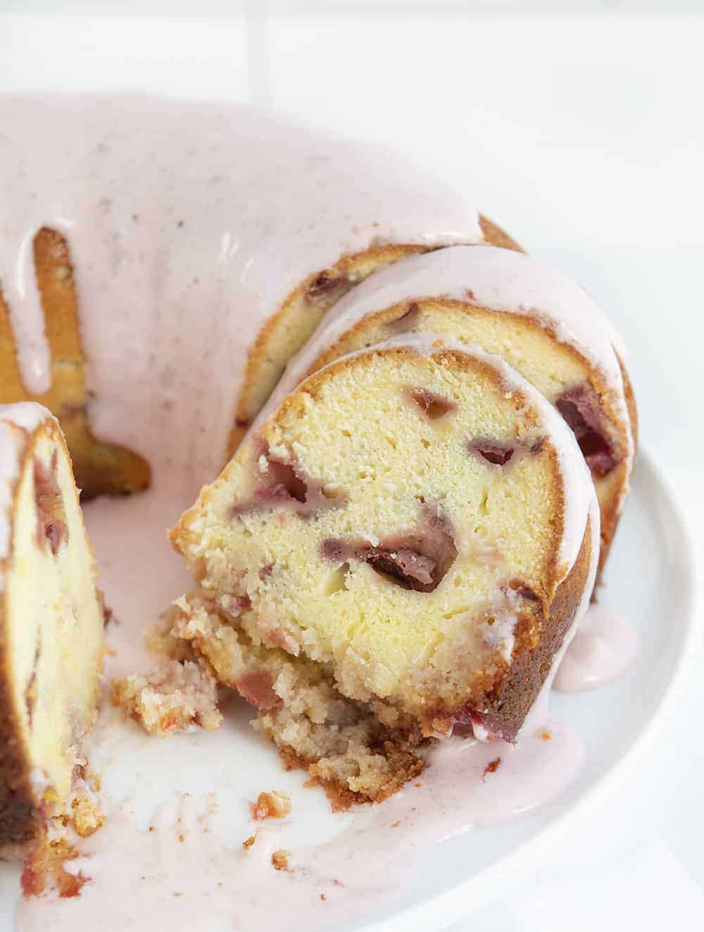 Strawberry Cream Cheese Pound Cake Cut up on a White Cake Stand