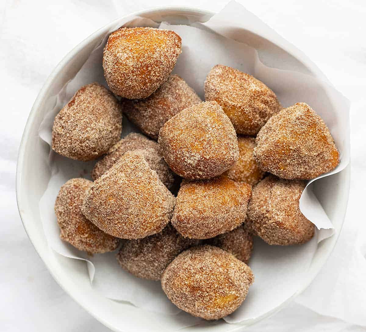 Overhead of Cinnamon Sugar Mini Donuts in White Bowl