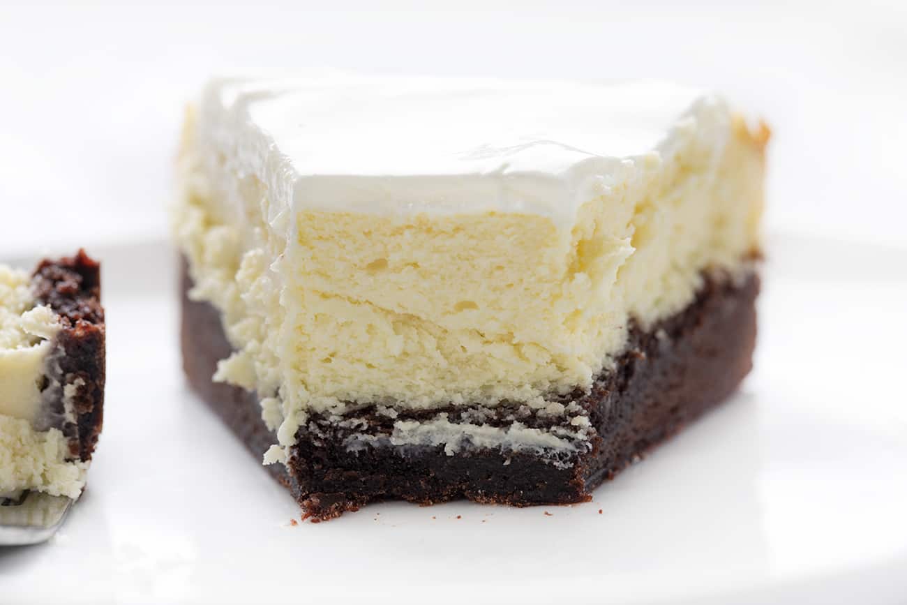 View of Cut Into Brownie Bottom Cheesecake showing the Inside and Fork next to it