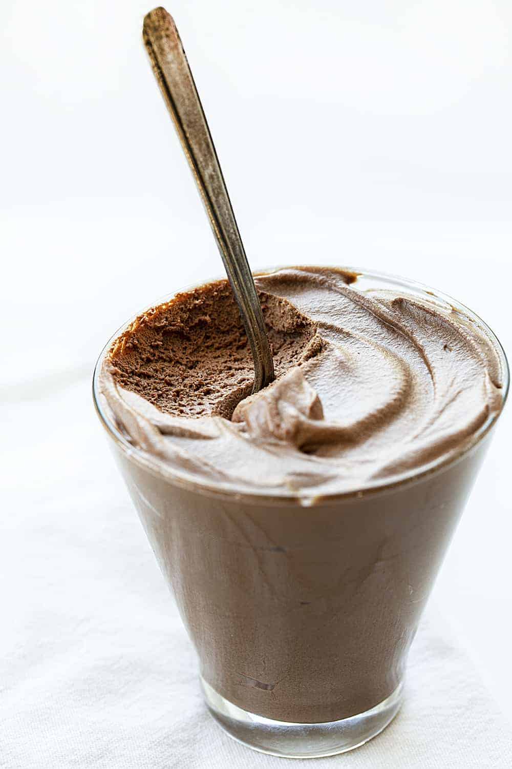 Cup of Rich Chocolate Mousse with Spoon Sticking Out