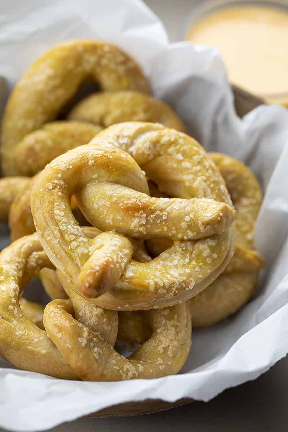 Basket of Sourdough Pretzels with Cheese Sauce in Background