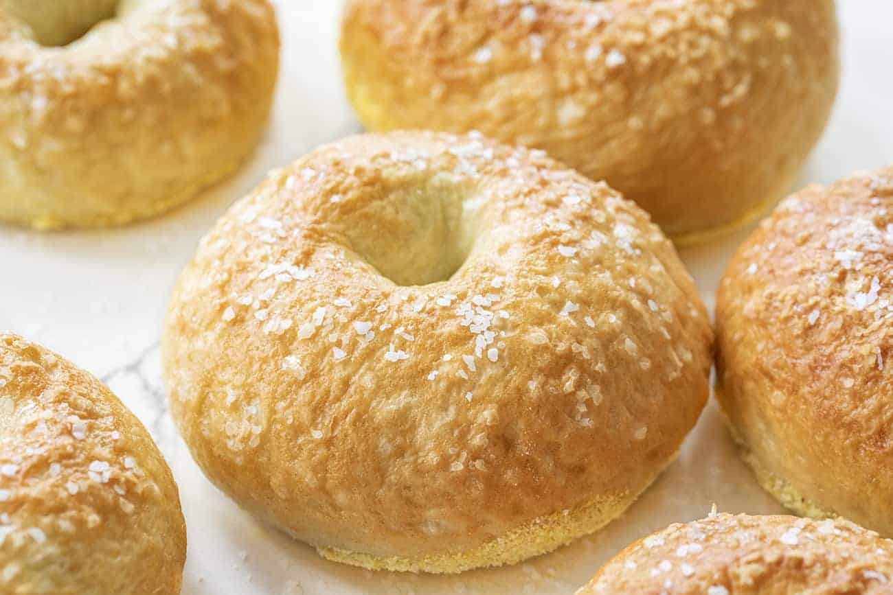 Close up of a Salt Bagel on Mable next to other salt bagels