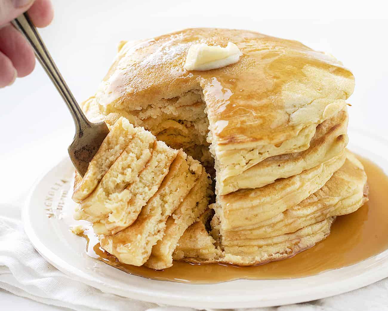 Stack of Sourdough Pancakes with Fork Removing a Section