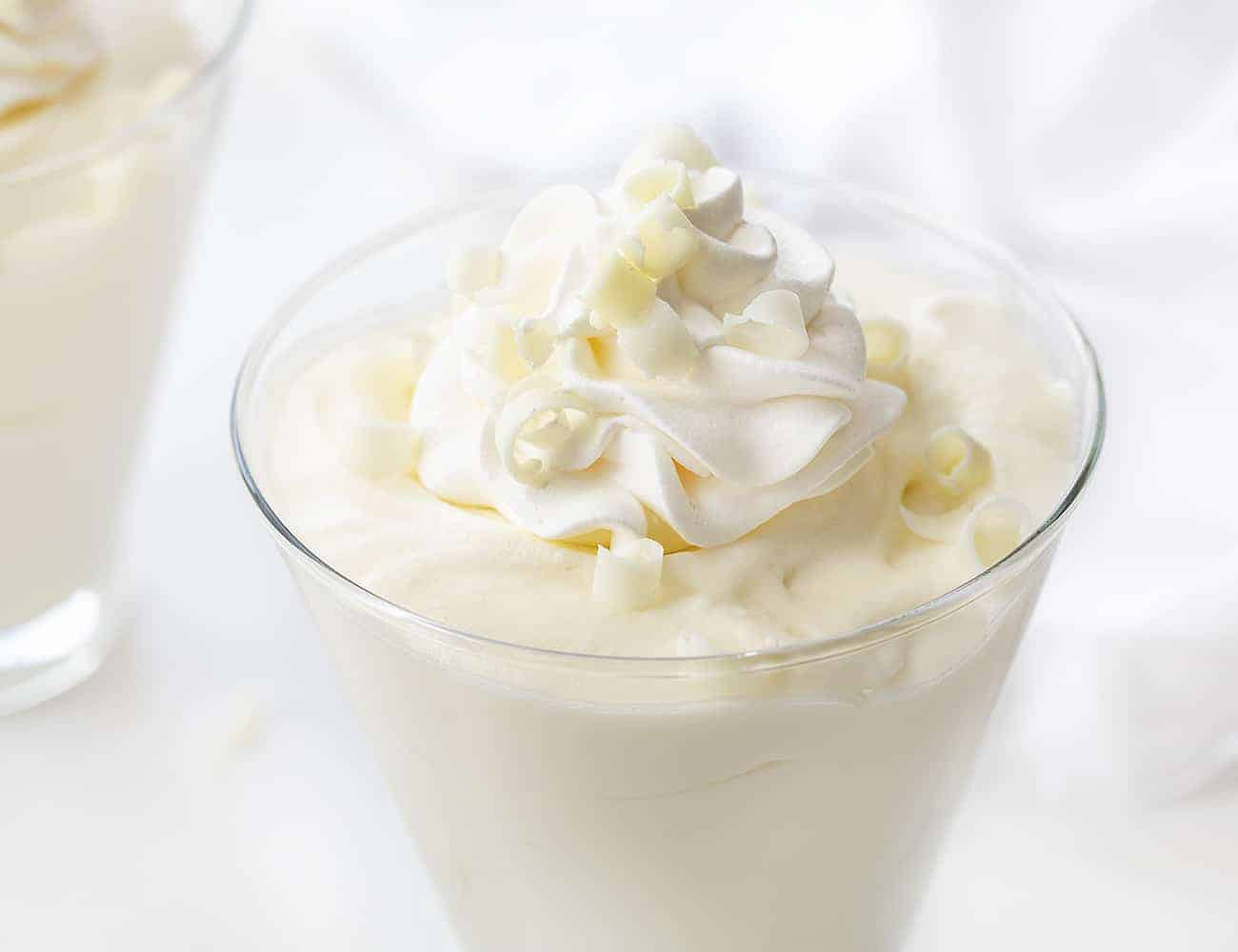 Close up of White Chocolate Mousse with Whipped Cream and White Chocolate Curls on Top