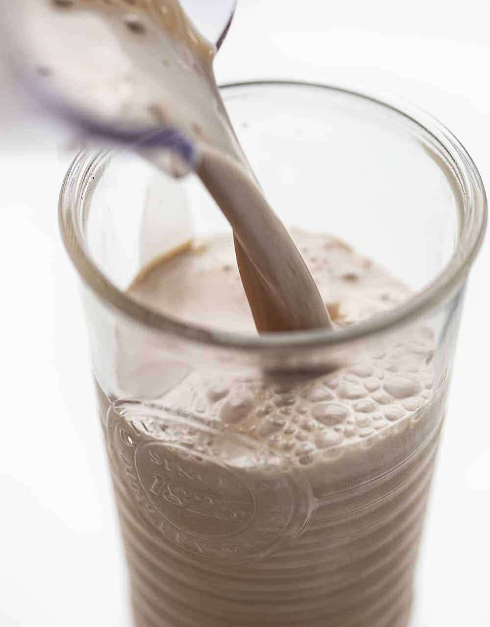 Pouring Homemade Chocolate Milk into Glass