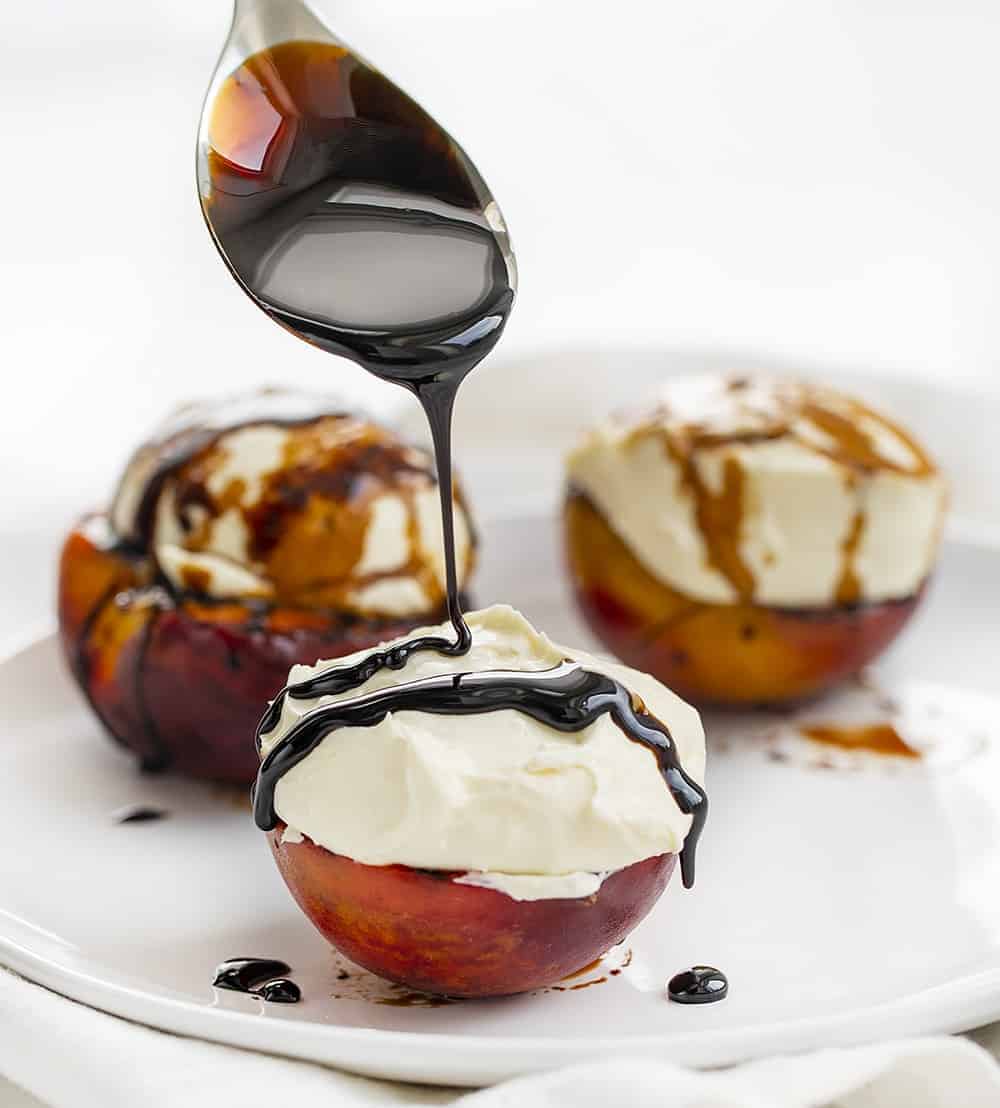 Drizzling Balsamic Glaze over Grilled Peaches with Vanilla Chai Cream