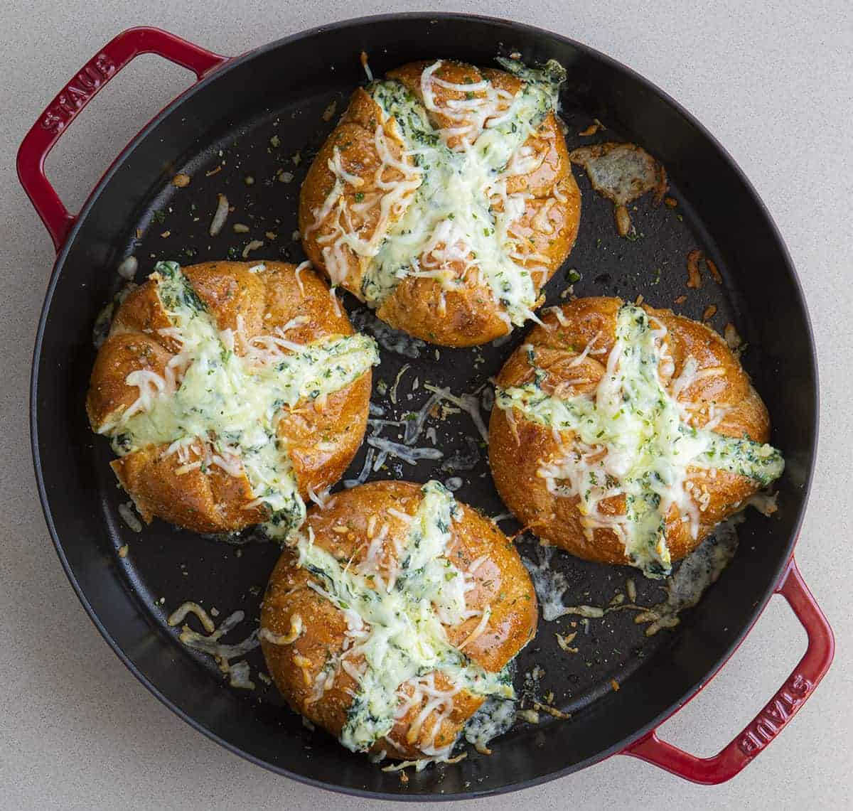Overhead view of Spinach Artichoke Pull Apart Bread in Red Skillet