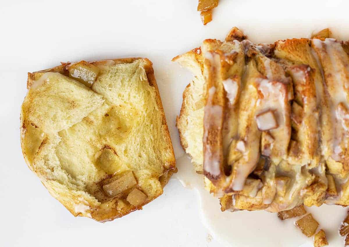 One Piece of Apple Pull Apart Bread Laying Flat on White Surface