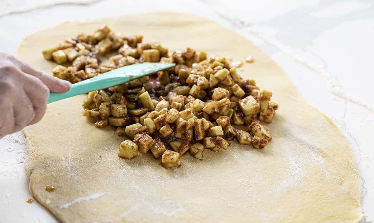 Spreading Apple Filling Over Dough for Apple Pull Apart Bread