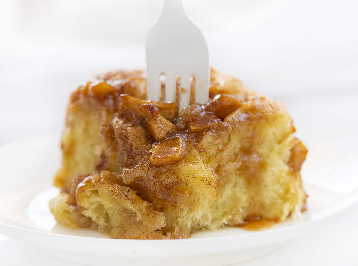 Apple Roll on a Plate with Fork Sticking Out of the Top