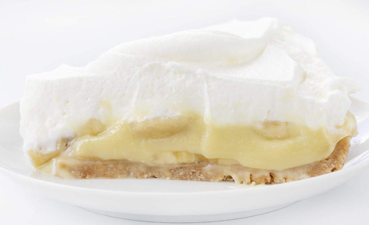 Slice of Banana Cream Pie on a White Plate