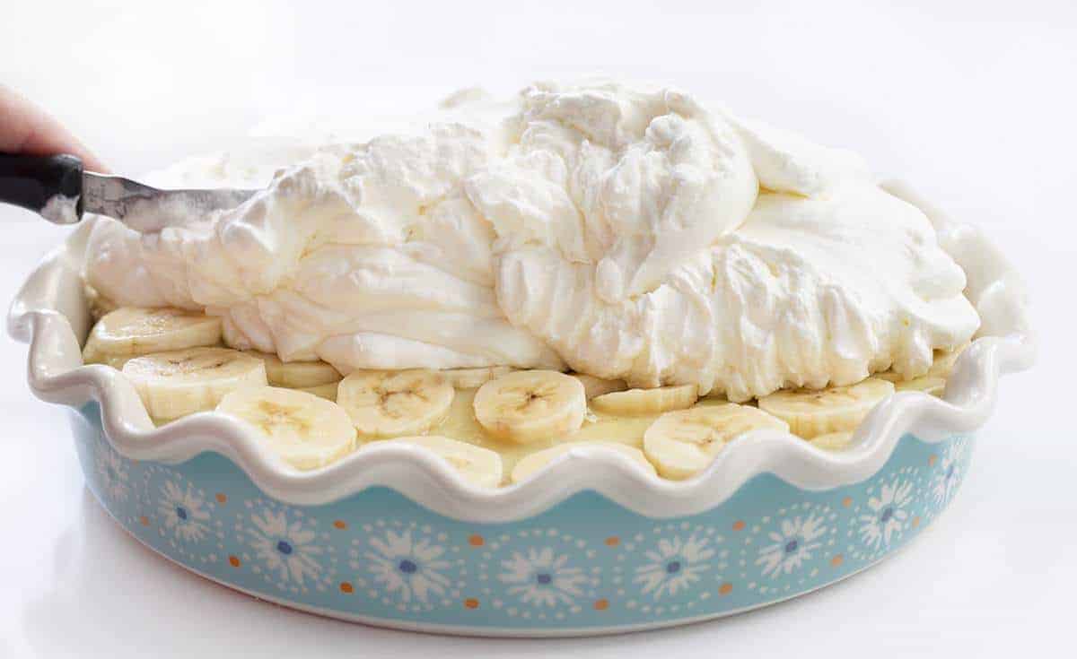 Spreading Fresh Made Whipped Cream over Banana Cream Pie