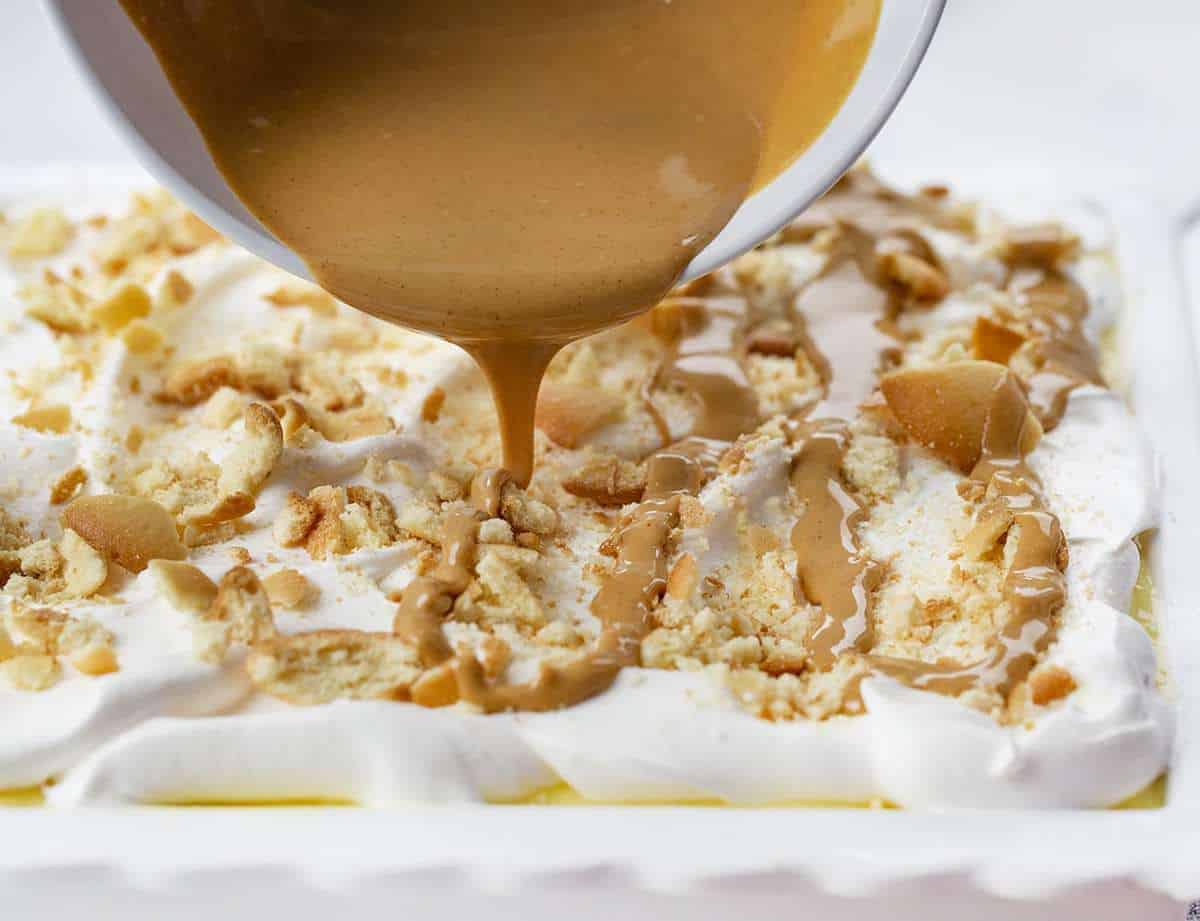Pouring Melted Peanut Butter over Banana Pudding Dessert 