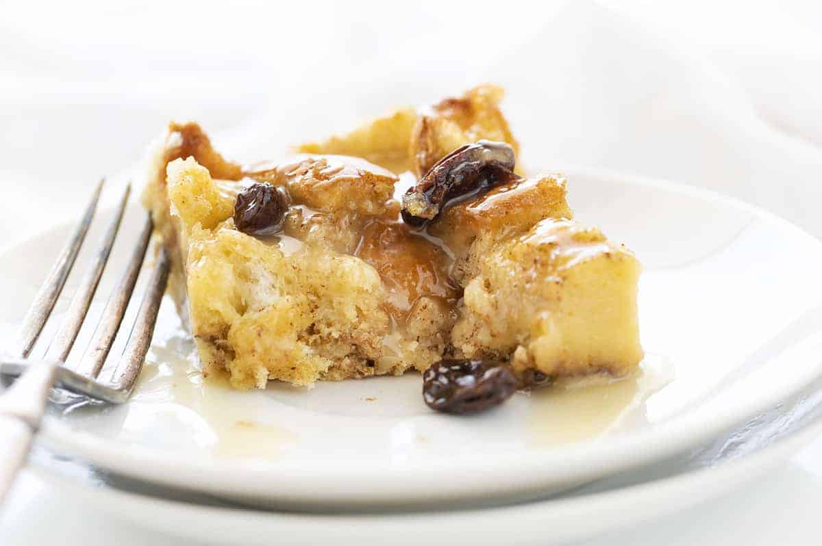 White Plate with Old Fashioned Bread Pudding Piece on it with One Bite Removed