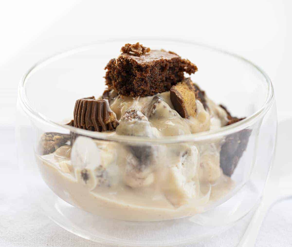 One Bowl of Brownie Peanut Butter Trifle with Reese's and White Spoon