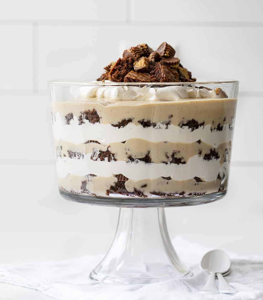 Brownie Peanut Butter Trifle in Trifle Dish on a Towel with White Spoons