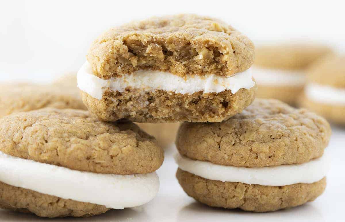 Three Oatmeal Cream Pie Cookies Stacked and A Bite Taken out of the Top Cookie