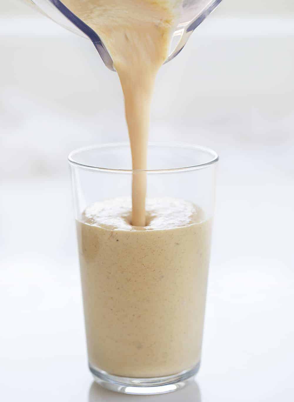 Pouring Peanut Butter Banana Smoothie into a Glass