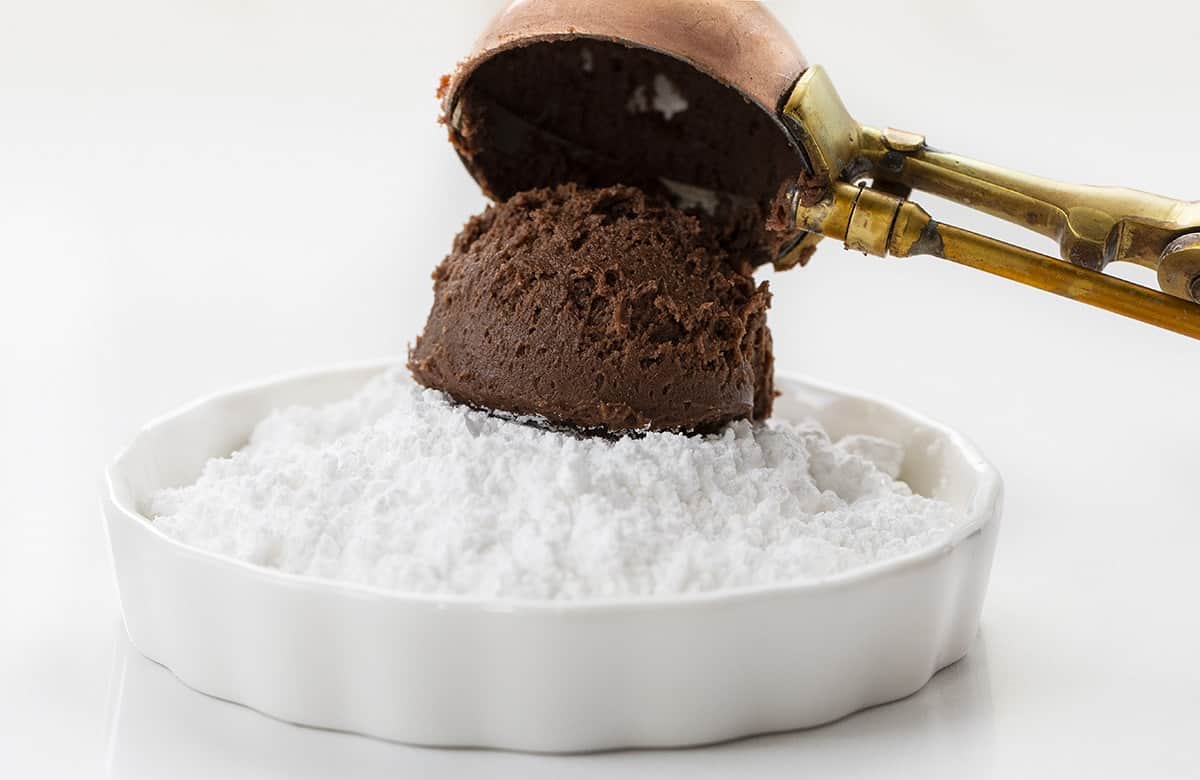 Dipping Chocolate Ooey Gooey Cookie Batter into Confectioners Sugar