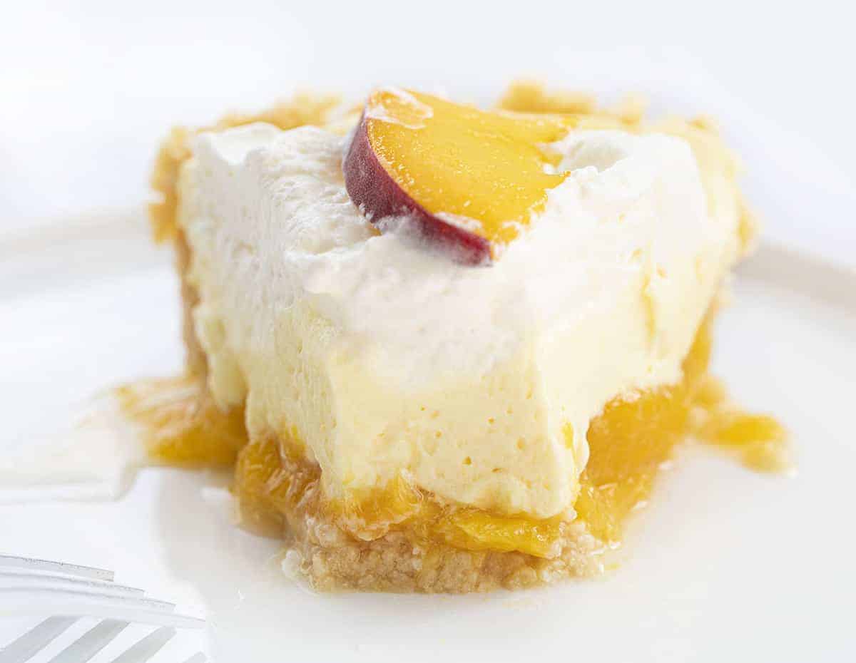 Piece of Peaches and Cream Pie on White Plate with Bite Missing