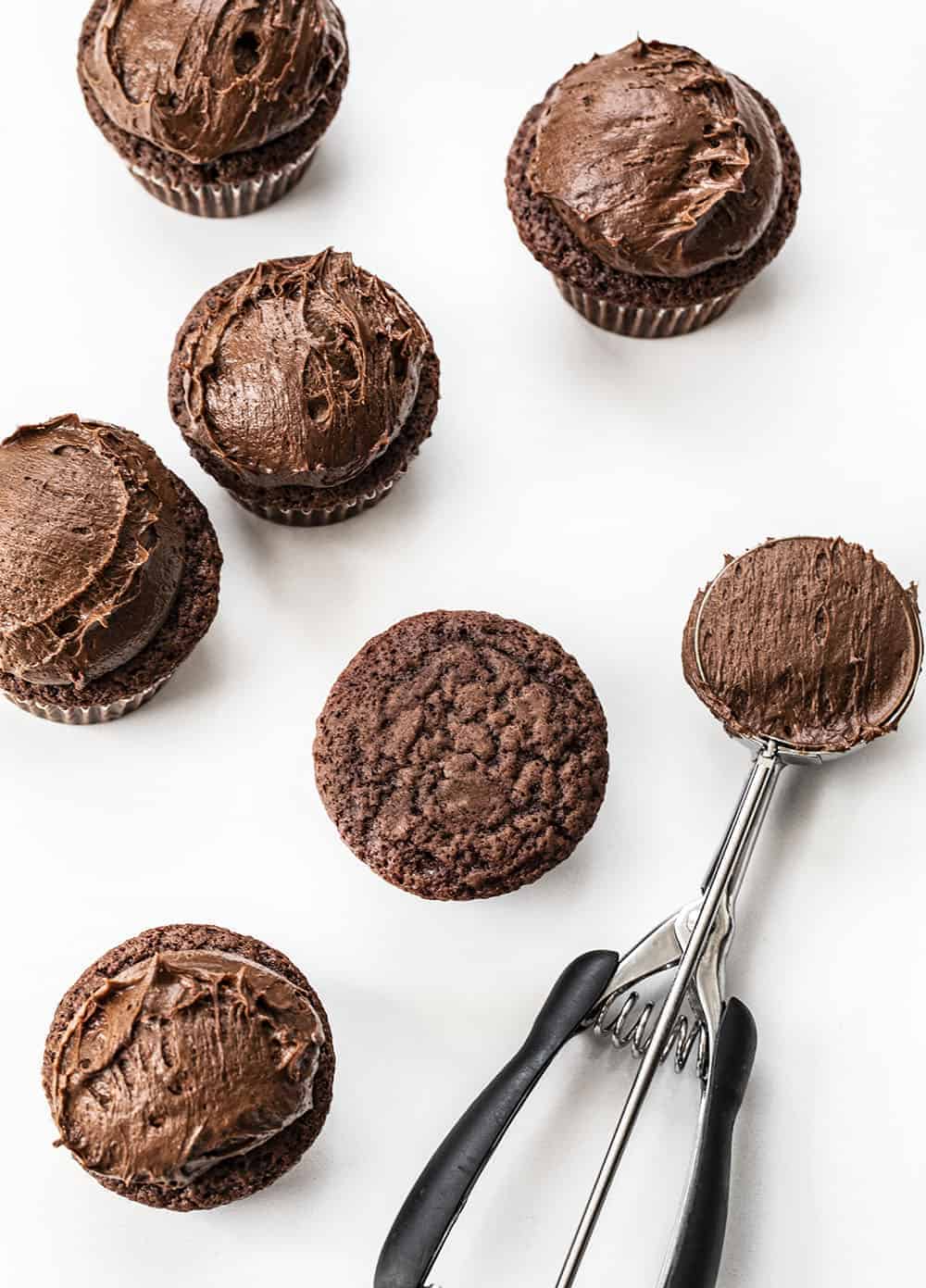 Adding Chocolate Frosting to Chocolate Brownie Cupcakes from Overhead