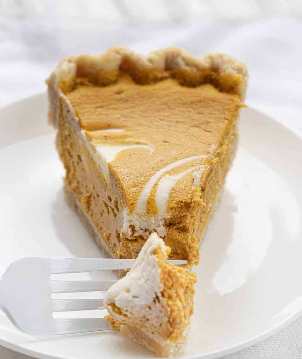 One Piece of Pumpkin Cream Cheese Pie on Plate with Fork Taking Bite