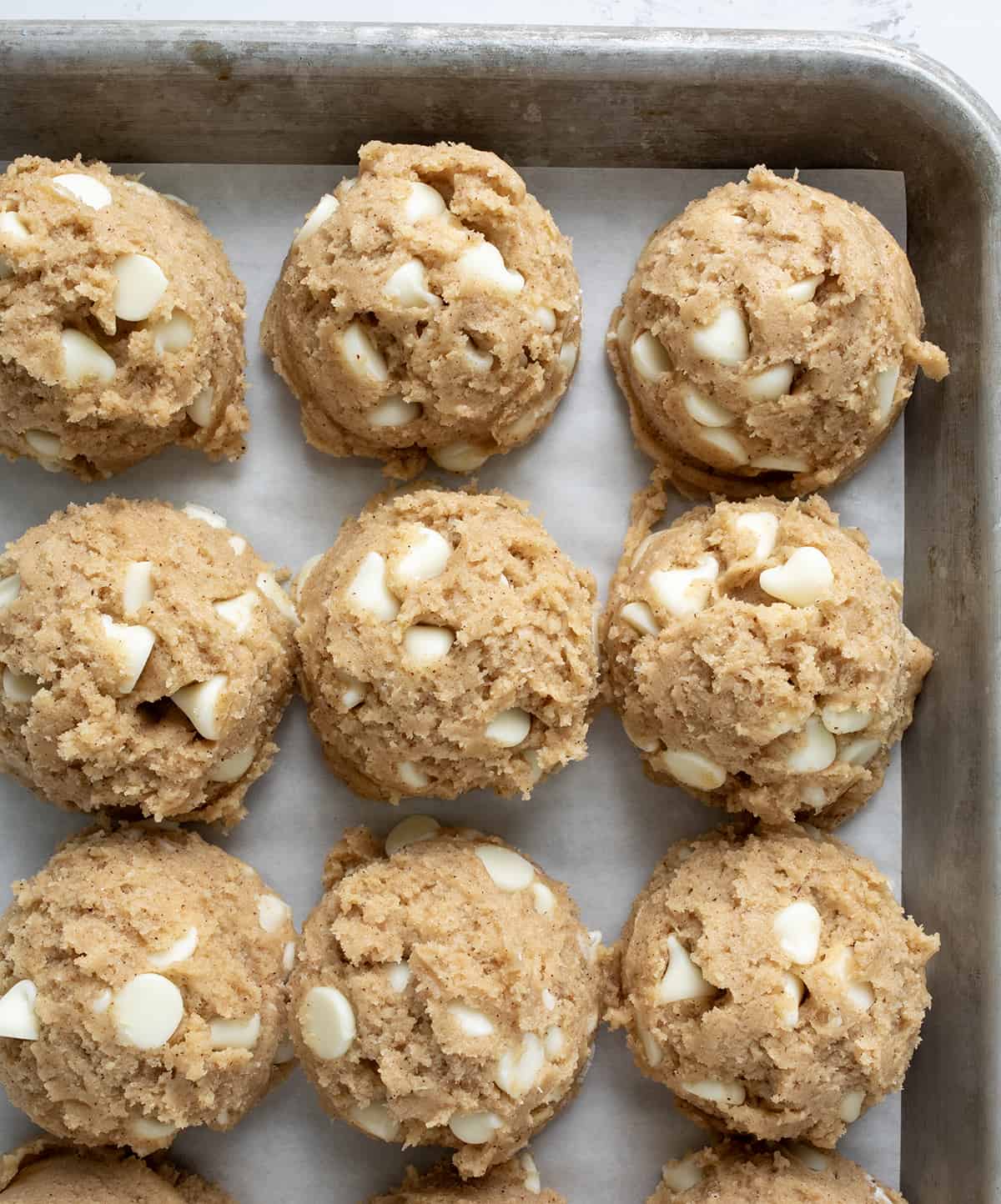 Raw White Chocolate Pumpkin Spice Cookie Dough Batter Scooped into Balls Before Baking.
