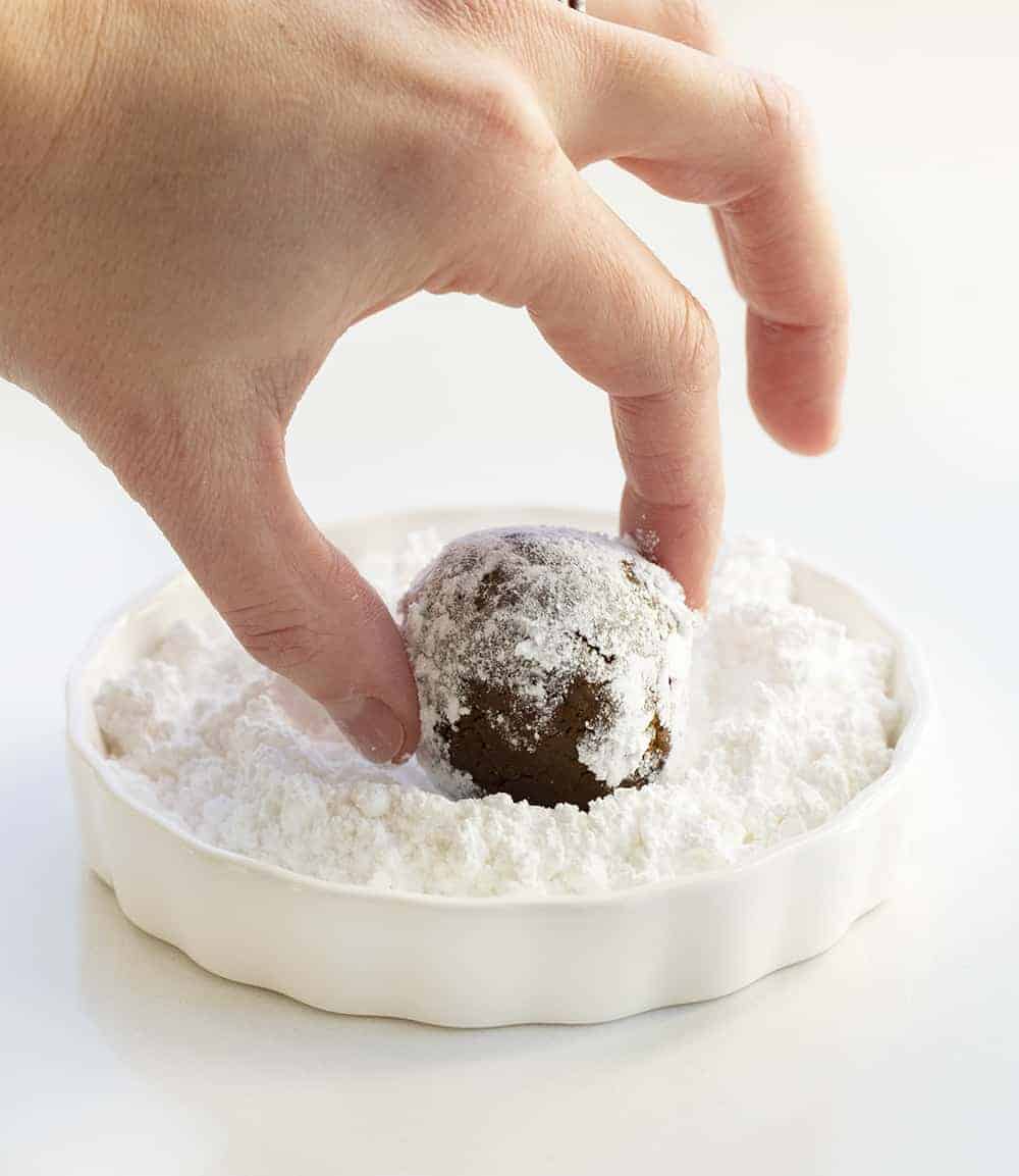 Rolling Dough in Confectioners Sugar for Gingerbread Crinkle Cookies