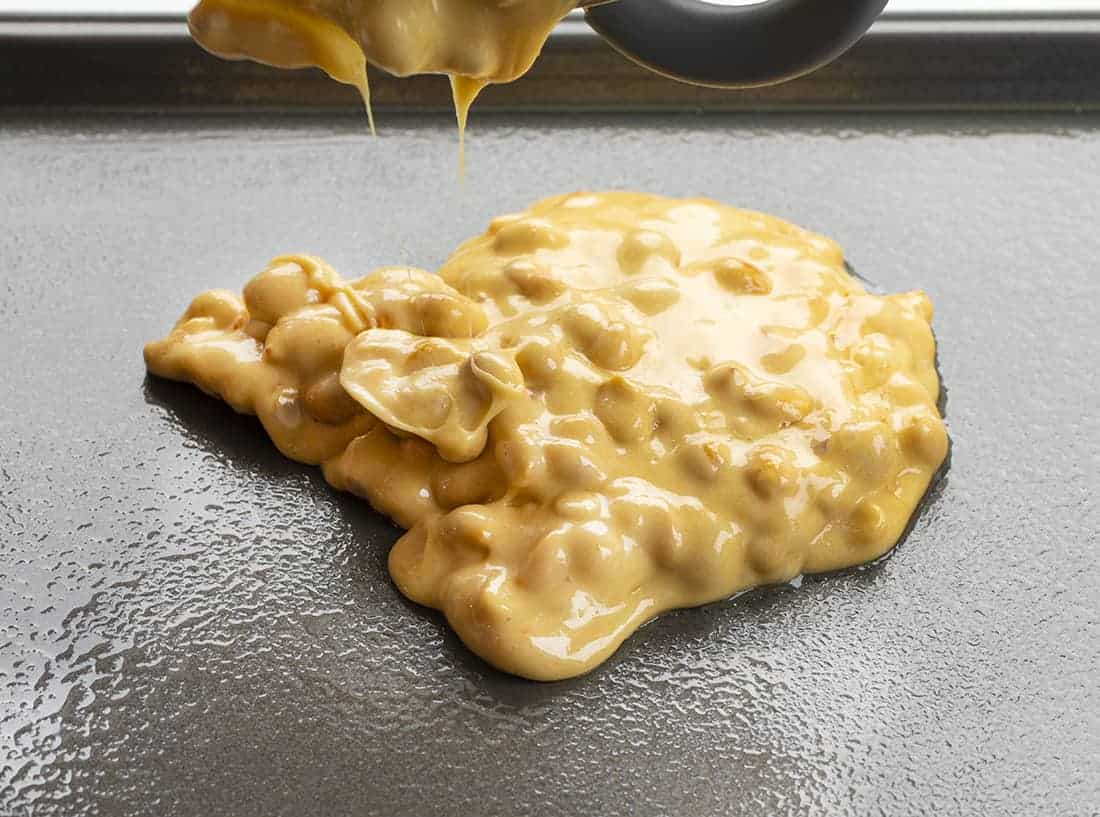 Pouring Classic Peanut Brittle on Greased Pan