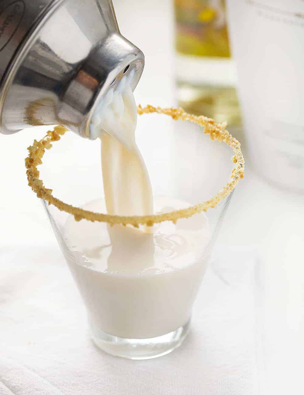 Banana Cream Pie Martini Being Poured Into Glass