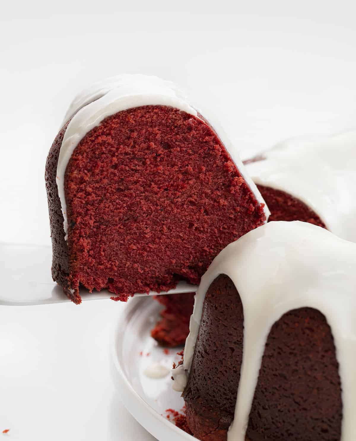 Picking up a Piece of Red Velvet Pound Cake with Cream Cheese Glaze