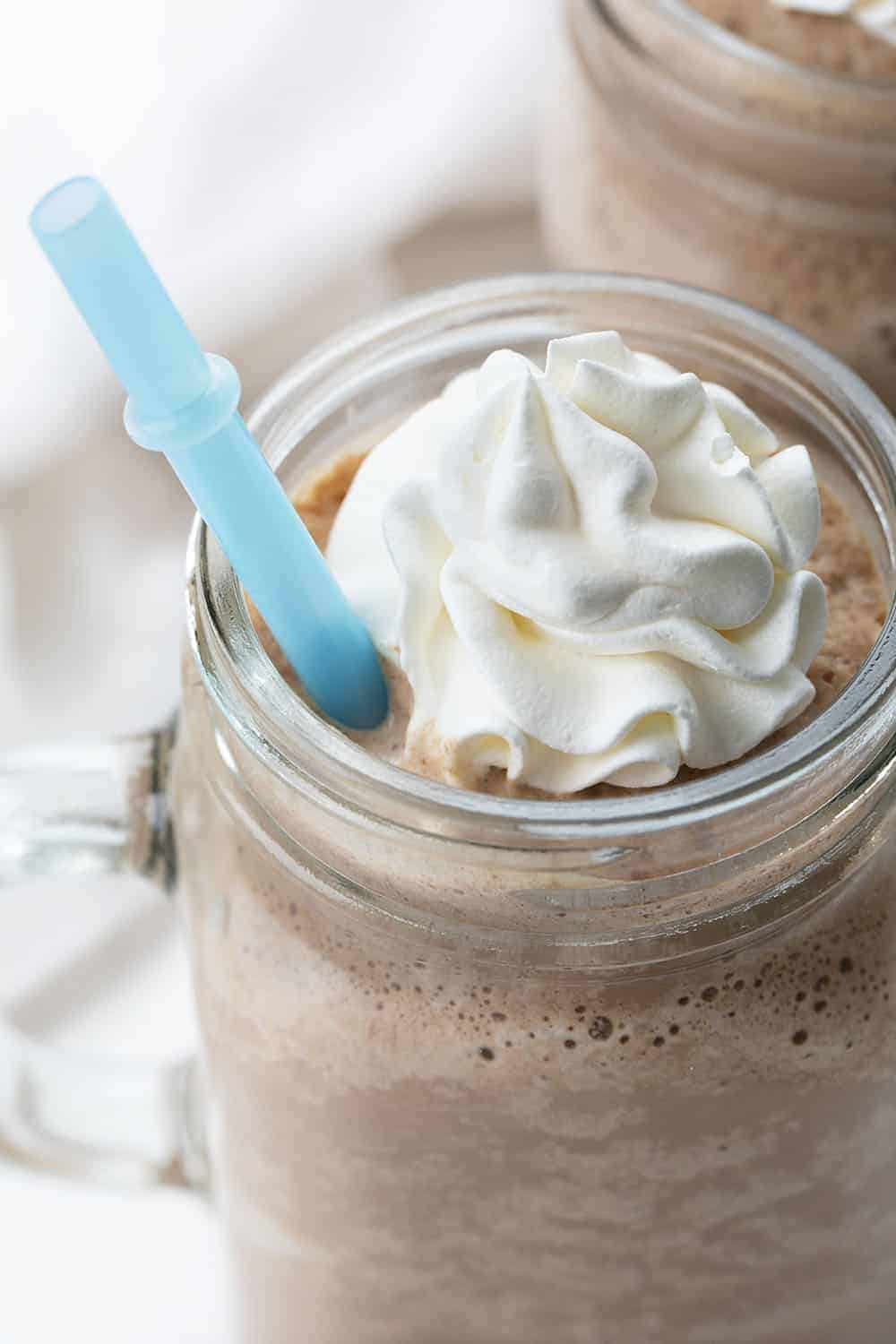 Close up of Frozen Hot Chocolate in Mugs with Blue Straw