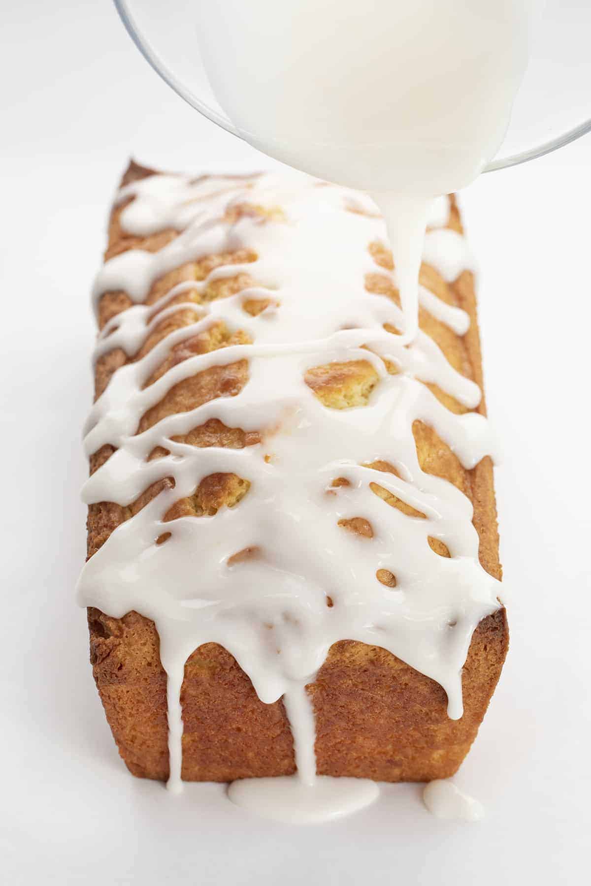 Pouring Lemon Glaze over Lemon Loaf