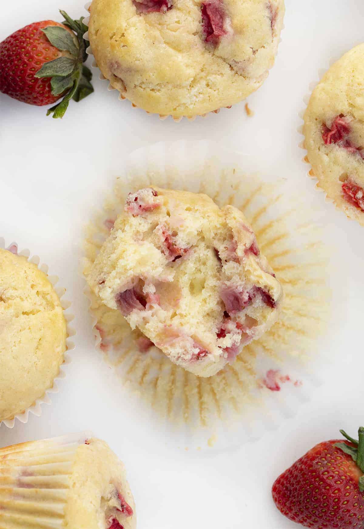 Overhead of Real Strawberry Muffins with One Halved to Show Inside