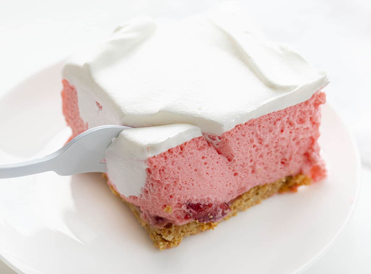 Fork Taking Bite of Strawberry Icebox Cheesecake