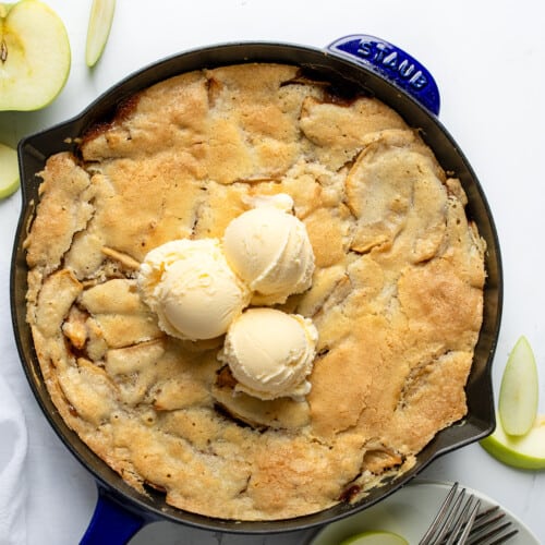 Swedish Apple Pie in a Skillet with Ice Cream on a White Table from Overhead.