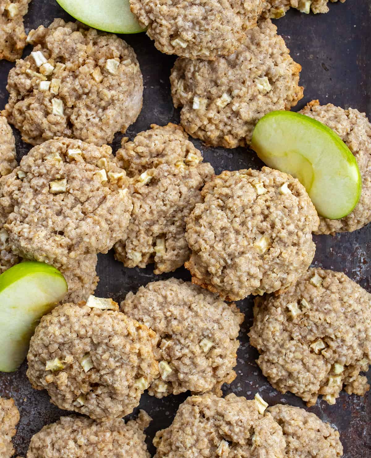 Apple Oatmeal Cookies on a Counter with Apple Slices from Overhead.