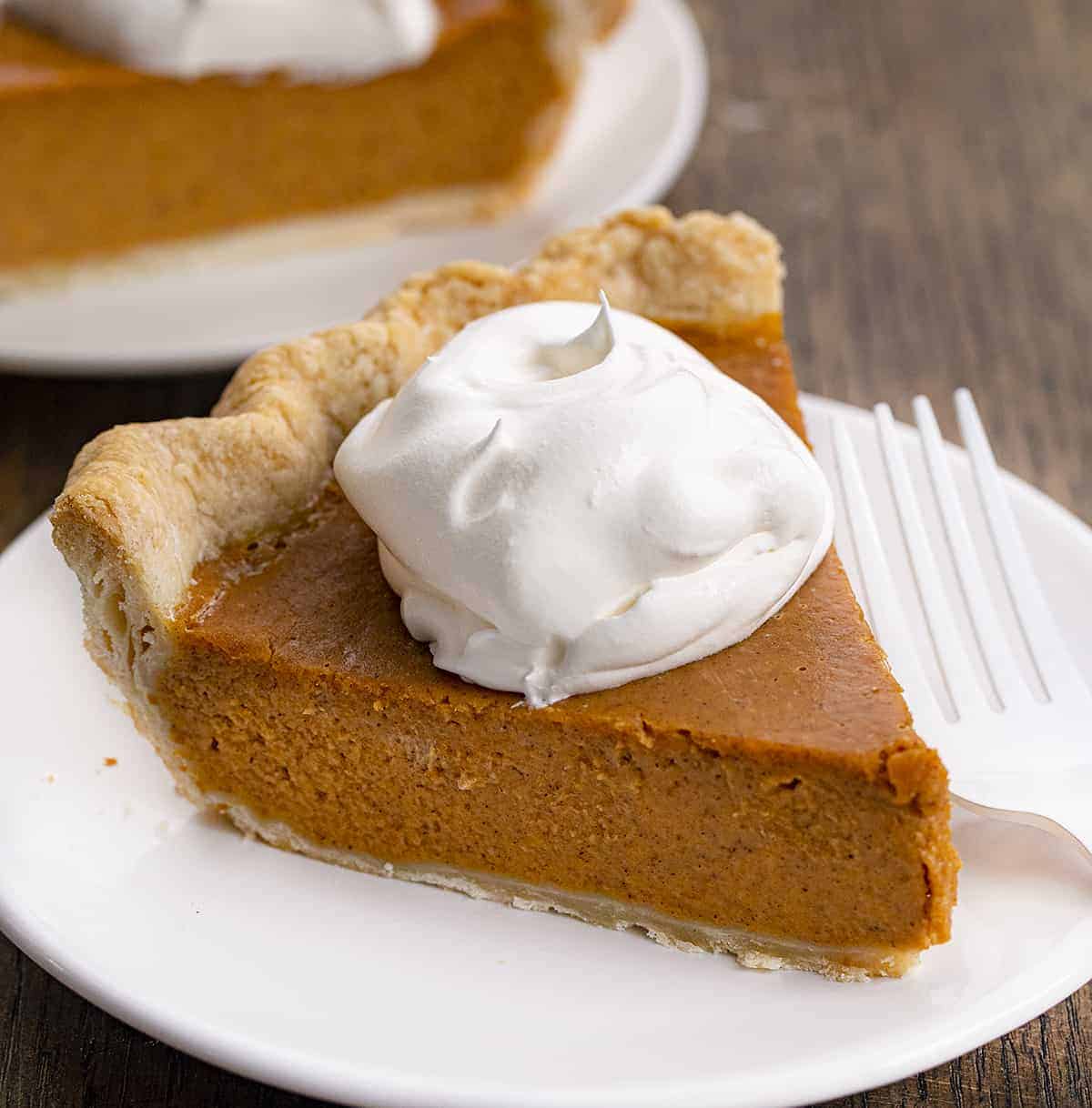 Pieces of Pumpkin Pie on White Plates