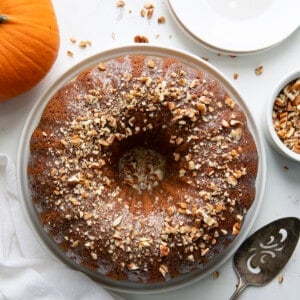 Overhead of a Pumpkin Spice Bundt Cake on a White Table.