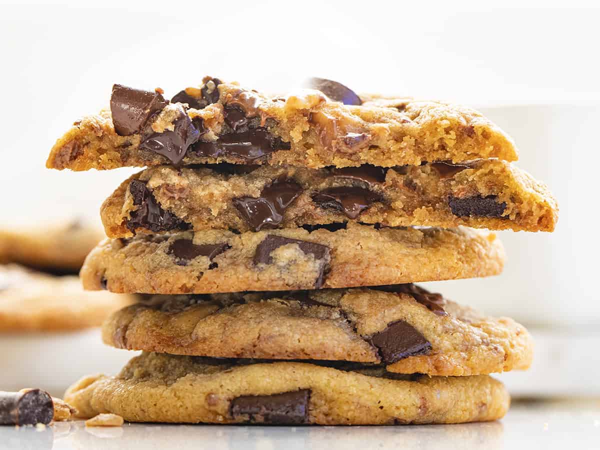 Stacked Brown Butter Toffee Cookies with Chocolate Chunks with one Broken in Half